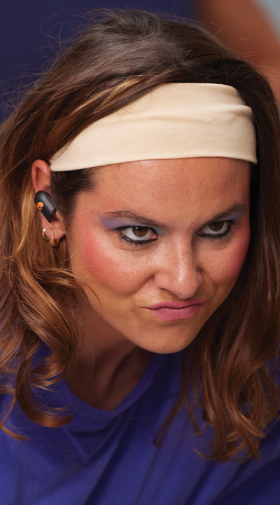 Fierce woman working out while using the Skullcandy Sesh ANC Active earbuds in black